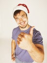 Funy exotical asian Santa claus in new years red hat smiling Royalty Free Stock Photo