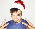 Funy exotical asian Santa claus in new years red hat smiling Royalty Free Stock Photo