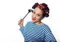 Funy housewife with curlers hold vintage iron and a ladle. free space for your text