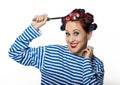 Funy housewife with curlers hold vintage iron and a ladle. free space for your text