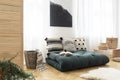 Green futon with pillows in boho bedroom interior with poster. Real photo Royalty Free Stock Photo