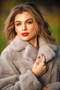 Fur boutique. Soft jacket furry texture. Sexy woman red lips wear fur coat. Businesswoman in fur coat. Simple and warm Royalty Free Stock Photo