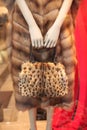 Fur coat and a bag made of natural lynx fur in the hands of a mannequin