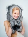 Fur Fashion. Small fashionista. Small girl wear winter hat scarf. Happy child smile in fashion style. Winter fashion