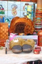 Fur hat and fur boots. Tibetan souvenirs on the table.