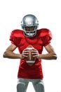 Furious American football player in red jersey and helmet holding ball