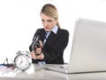 Furious angry businesswoman working pointing gun to alarm clock in out of time concept Royalty Free Stock Photo