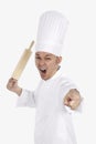 Furious Asian chef with a rolling pin. Conceptual image