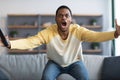 Furious black guy watching football game on TV