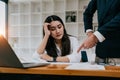 Furious boss scolding young frustrated interns. Ineffective office workers sitting at the table and listening to Royalty Free Stock Photo