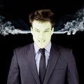 Furious businessman getting green face