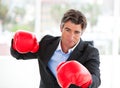 Furious businessman wearing boxing gloves Royalty Free Stock Photo