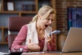 Furious businesswoman shouting expressively to smart phone while answering phone call at office. Angry annoyed woman Royalty Free Stock Photo