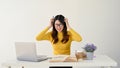 A furious female college student is pulling her hair with anger while working on a hard project Royalty Free Stock Photo