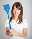 Furious girl with flyswatter Royalty Free Stock Photo