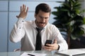 Furious male boss frustrated by cellphone problems Royalty Free Stock Photo