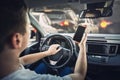 Furious man driver honking the car horn angry on the traffic jam ahead. Aggressive guy unsafe driving while using his phone in Royalty Free Stock Photo