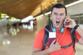 Furious man getting a call at the airport