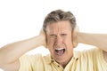 Furious Man Screaming While Covering His Ears Royalty Free Stock Photo