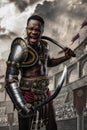 Furious roman gladiator of african ethnic with two swords Royalty Free Stock Photo