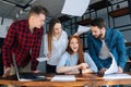 Furious sad young business woman under stress throwing documents sitting at desk looking at camera, multi-ethnic Royalty Free Stock Photo