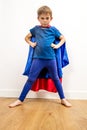 Furious superhero child standing, claiming empowerment with strong body language Royalty Free Stock Photo