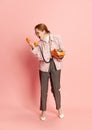 Furious woman, office manager in costume, eyeglasses and heels shouting at telephone receiver over pink background Royalty Free Stock Photo