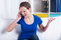 Furious woman talking on a phone Royalty Free Stock Photo