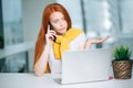 Furious woman wearing suit working on line using smart phone in a desk at office Royalty Free Stock Photo