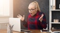 Furious woman working on laptop at office