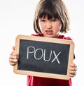 Furious young boy repulsing head lice with school slate Royalty Free Stock Photo