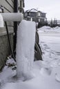 Furnace exhaust vent with Icicle from dripping water Royalty Free Stock Photo