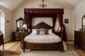 Furnished bedroom within former victorian rectory with ornate carved four poster bed and matching period sideboard drawers, chaise