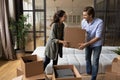 Millennial husband wife carrying boxes with stuff to new apartment Royalty Free Stock Photo