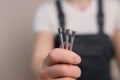 Furniture assembler holds countersunk screws in his hand, close-up. Construction concept, handyman Royalty Free Stock Photo