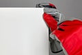 Furniture assembler in red gloves is screwing in a screw with a Royalty Free Stock Photo