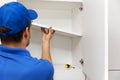 Furniture assembly - worker installing cabinet shelf Royalty Free Stock Photo