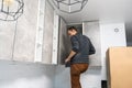 furniture assembly - worker installing cabinet shelf Royalty Free Stock Photo