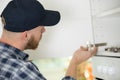 furniture assembly - worker installing cabinet shelf Royalty Free Stock Photo