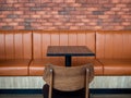 Furniture decoration in cafe retro style. Empty wood table bar and orange long leather sofa Royalty Free Stock Photo