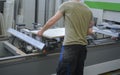 Furniture factory - worker while preparing to cut a plank of wood