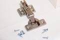 Furniture hinge in the new kitchen cabinet door closeup. Royalty Free Stock Photo