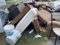 Furniture piled up from eviction on curb