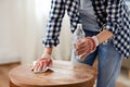 woman degreasing old table surface with solvent