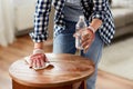 woman degreasing old table surface with solvent Royalty Free Stock Photo