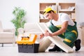 The furniture repairman repairing armchair at home Royalty Free Stock Photo