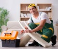 Furniture repairman repairing armchair at home Royalty Free Stock Photo