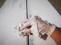 Furniture restoration and worker s hands in a dirty broken rubber gloves