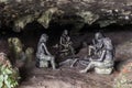 FURONG ZHEN, CHINA - AUGUST 11, 2018: Sculptures of prehistoric people in a cave under the waterfall in Furong Zhen town Royalty Free Stock Photo