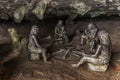 FURONG ZHEN, CHINA - AUGUST 11, 2018: Sculptures of prehistoric people in a cave under the waterfall in Furong Zhen town